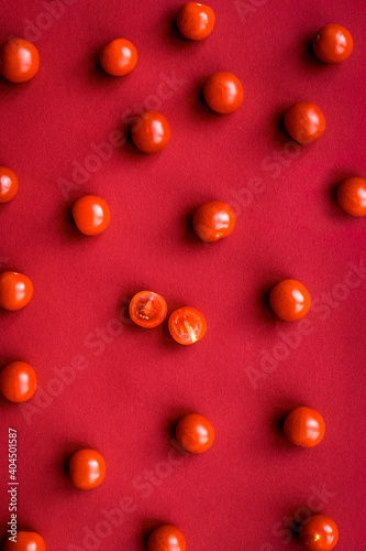 Ripe fresh cherry on red colored background top view pattern