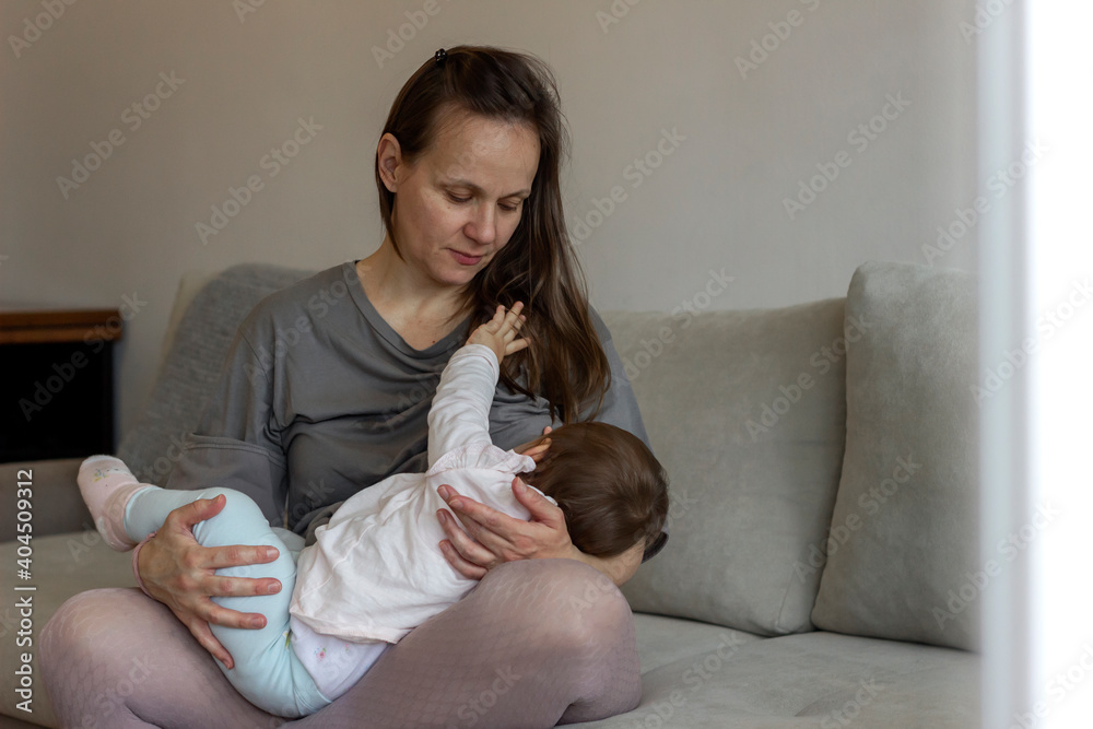 Shot of a beautiful mother breastfeeding her newborn child. Baby eating