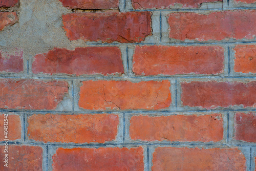 Old brick wall with devastating bricks for background.