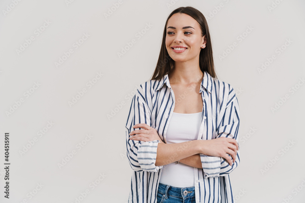 Happy beautiful brunette girl smiling while posing with arms crossed Happy beautiful brunette girl smiling while posing with arms crossed