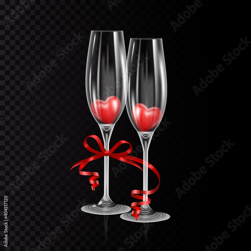 Two empty glasses of champagne with hearts and red ribbon, isolated.
