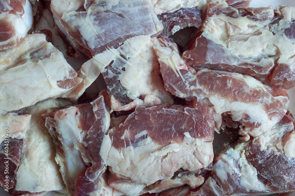Close-up cut lamb ribs. Detail raw meat texture as background.