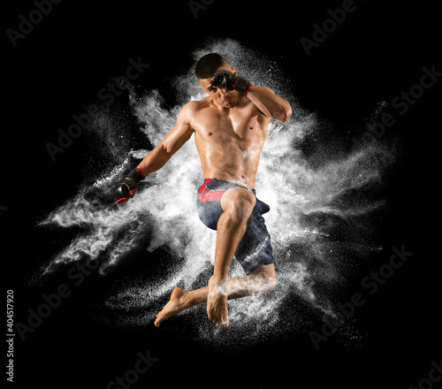 MMA male fighter kick. White smoke background