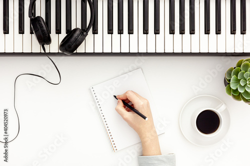 songwriter or dj work place with synthesizer and headphones