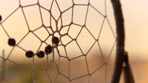 Extreme Close Up Shot of Dreamcatcher Web Spinning In the Wind photo