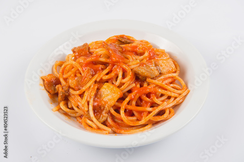 bucatini or spaghetti all'amatriciana are a typical pasta dish of the culinary tradition of Rome and the Lazio region in Italy prepared with pancetta and tomato sauce