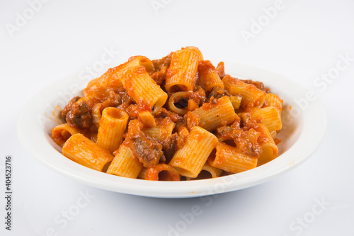 pasta con coda alla vaccinara is a typical dish from the area of Rome and the Lazio region prepared with cooked beef tail, isolated on white background photo