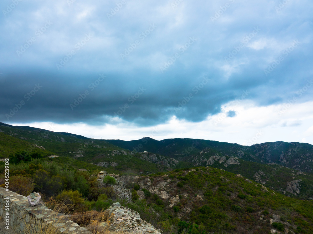 Φωτογραφία Beautiful landscape of mountains in the desert des Agriates, dramatic sky and cumulus clouds