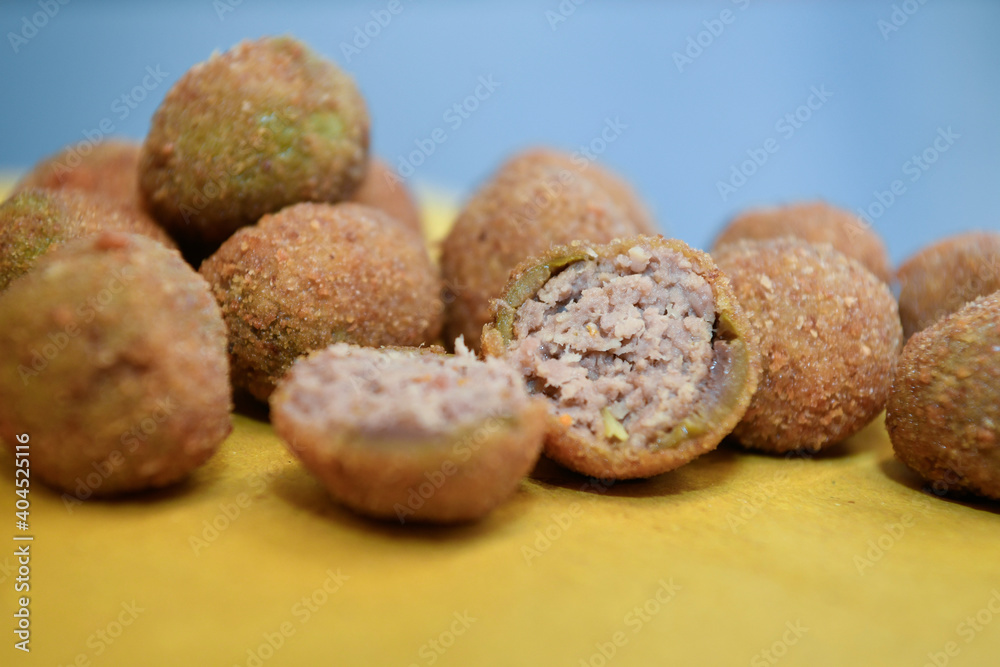 artisanal ascolana olives called Olive all'ascolana or olive ascolane are a typical dish from the Marche region, from the city of Ascoli Piceno in Italy. artisanal ascolana olives called Olive all'ascolana or olive ascolane are a typical dish from the Marche region, from the city of Ascoli Piceno in Italy.