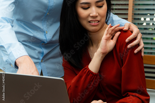 Bilde på lerret Boss touching shoulder of a young female employee in office at workplace