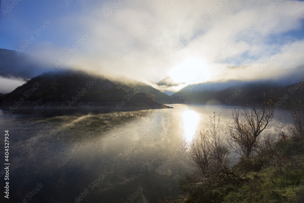 A foggy day at Lake Turano. The colors of autumn in Castel di Tora in Rieti A foggy day at Lake Turano. The colors of autumn in Castel di Tora in Rieti