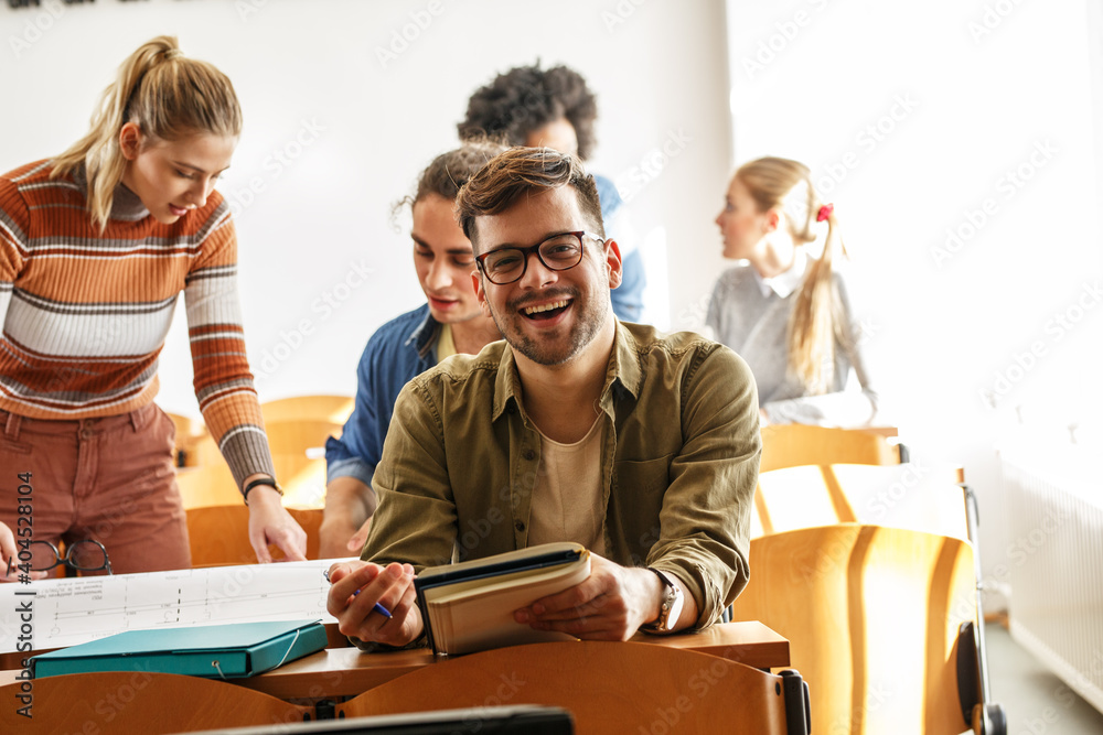 Portrait of young male university student taking a test in a classroom.Educational concept.
Portrait of young male university student taking a test in a classroom.Educational concept.