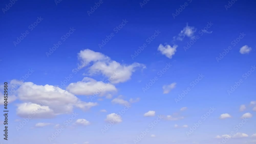 Time-lapse of cloudscape, white clouds in blue sky Time-lapse of cloudscape, white clouds in blue sky
