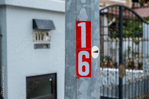 Lamp post in the street with the number 16. Stock Photo.