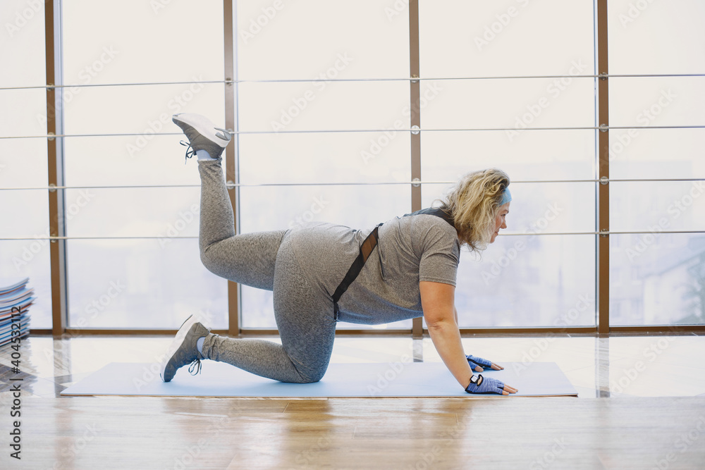 Fototapeta premium Fat woman dieting, fitness. Portrait of obese woman working out in gym.