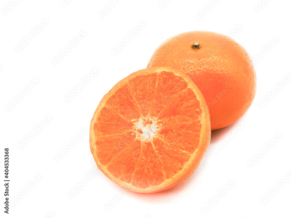 Fotografie Fresh orange fruit cut in half placed on a white background.