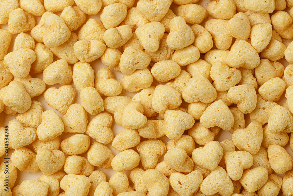 Heart shape breakfast cereals made of wheat or oats. Food background of breakfast cereals or bran in general plan Heart shape breakfast cereals made of wheat or oats. Food background of breakfast cereals or bran in general plan
