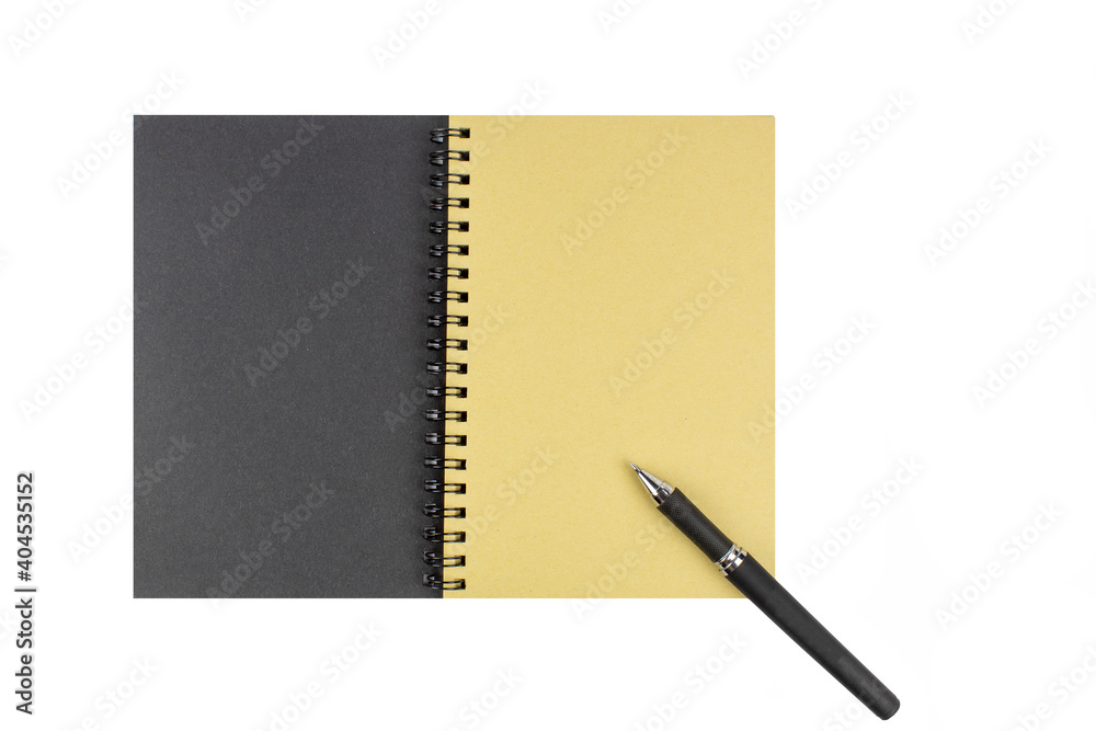 An open diary with a textured surface and yellowed pages and a black ballpoint pen. An open diary with a textured surface and yellowed pages and a black ballpoint pen.