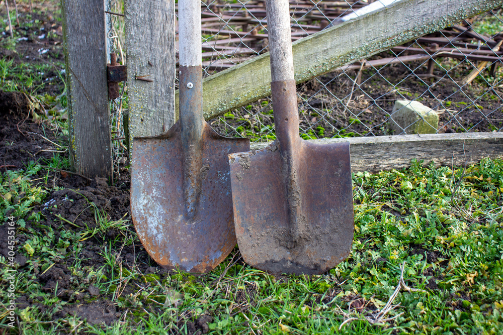 Two shovels on the ground near the grid. Two shovels on the ground near the grid.