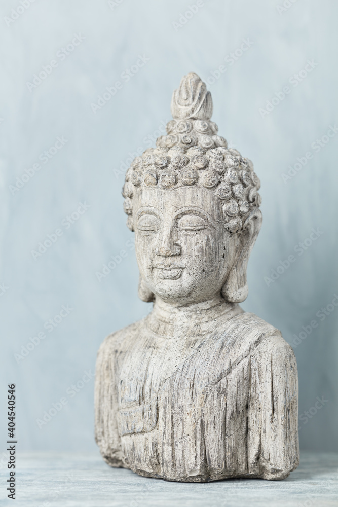 Meditating Buddha Statue on bright background.