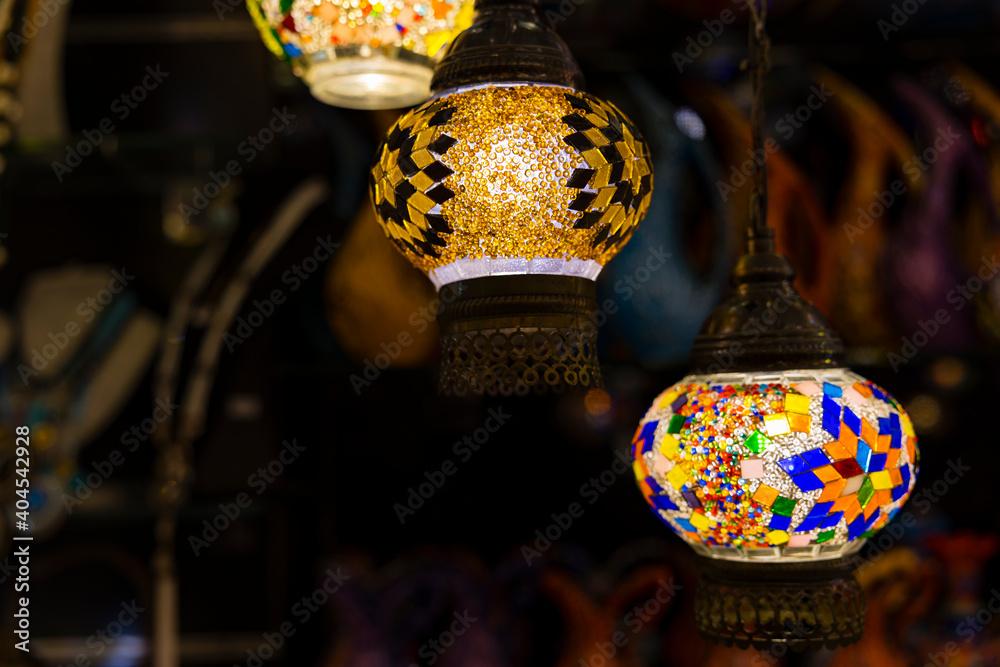 Traditional handmade multicolor Turkish, Moroccan, Arabian lamps hanging with nice blurred background. Mosaic style and colored glass lantern. Suitable for Ramadan Kareem greeting.