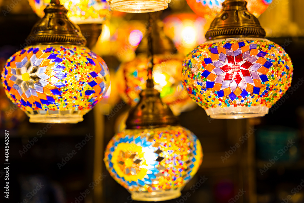 Traditional handmade multicolor Turkish, Moroccan, Arabian lamps hanging with nice blurred background. Mosaic style and colored glass lantern. Suitable for Ramadan Kareem greeting.