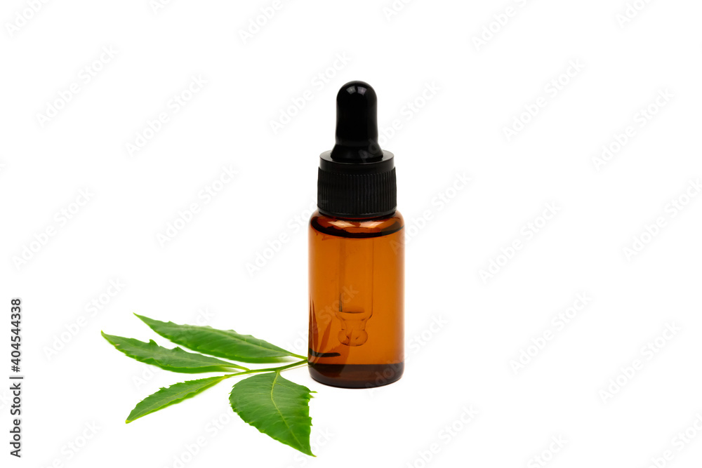 Neem oil in bottle and fresh neem leaf isolated on white background. Neem oil in bottle and fresh neem leaf isolated on white background.