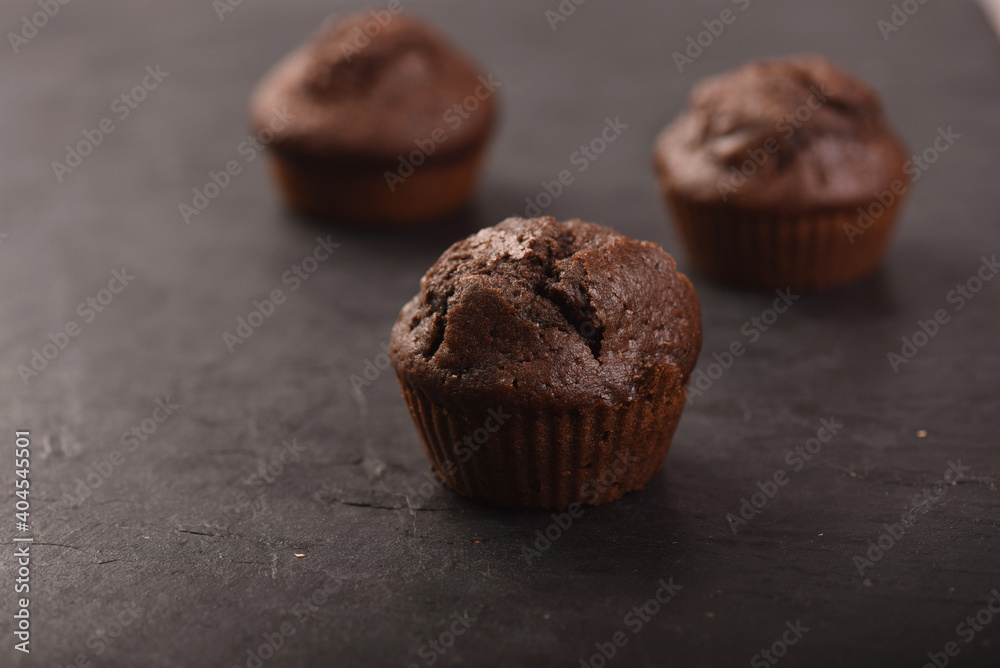 Close-up of homemade chocolate muffins with on a dark background. Close-up of homemade chocolate muffins with on a dark background.