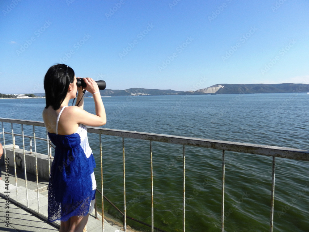 the girl look through binoculars. Photo of a girl who admires the view of mountains and river through binoculars.
the girl look through binoculars. Photo of a girl who admires the view of mountains and river through binoculars.