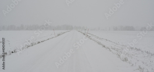 straight winter road covered in snow in Sweden
