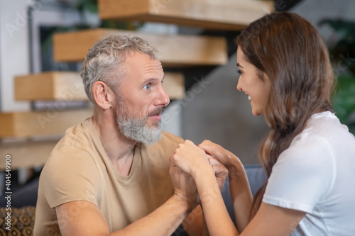 Bearded man and young woman enjoying being together