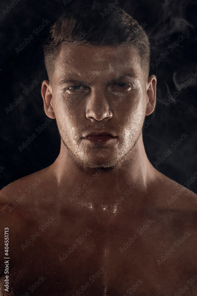 Sexy sport muscle fit strongface guy with white towel on black isolated  font background with smoke