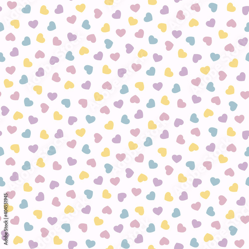 Seamless pattern of small scattered pastel hearts. 