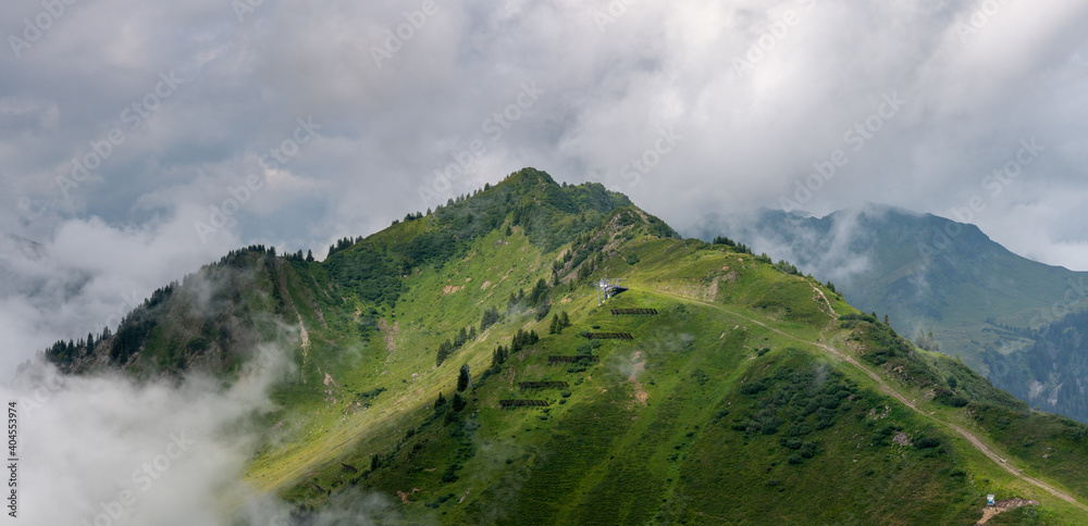 view with the top of mount Muttelbergkopf in Austria among heavy clouds