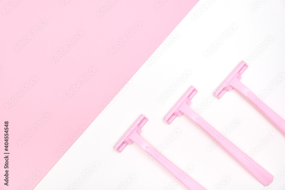 Pink disposable plastic woman razor blade for shaving, body care and unwatred hair removing on legs, armpits and face, flat lay with copy space Pink disposable plastic woman razor blade for shaving, body care and unwatred hair removing on legs, armpits and face, flat lay with copy space