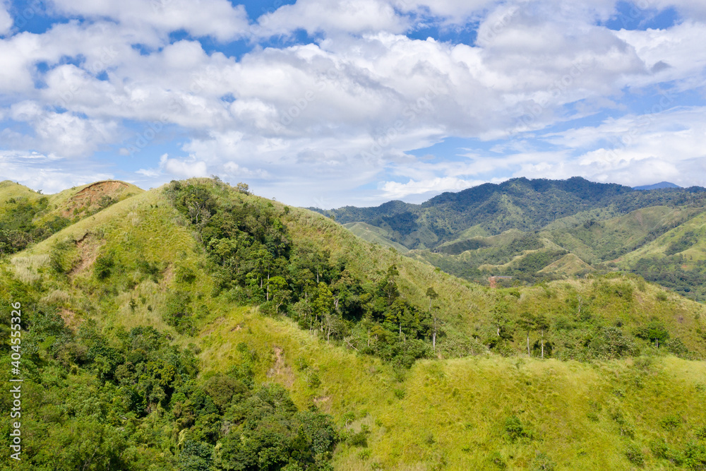 Obraz premium Summer mountains green grass and blue sky landscape. Mountain landscape on the Luzon island in sunny weather.