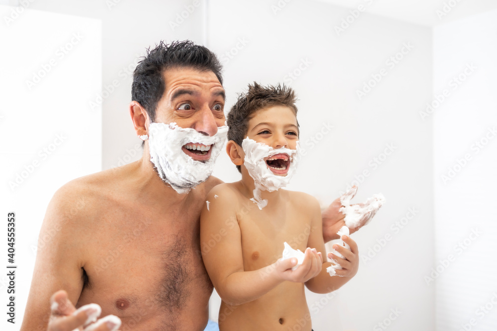 Funny father and son shaving in the bathroom