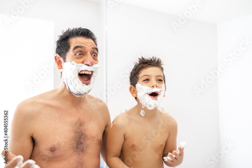 Funny father and son shaving in the bathroom photo