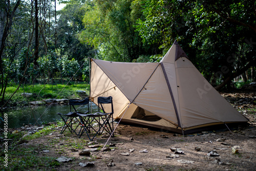 Camping tent and equipment accessory in the forest Thailand. Adventure vacation relaxation concept.