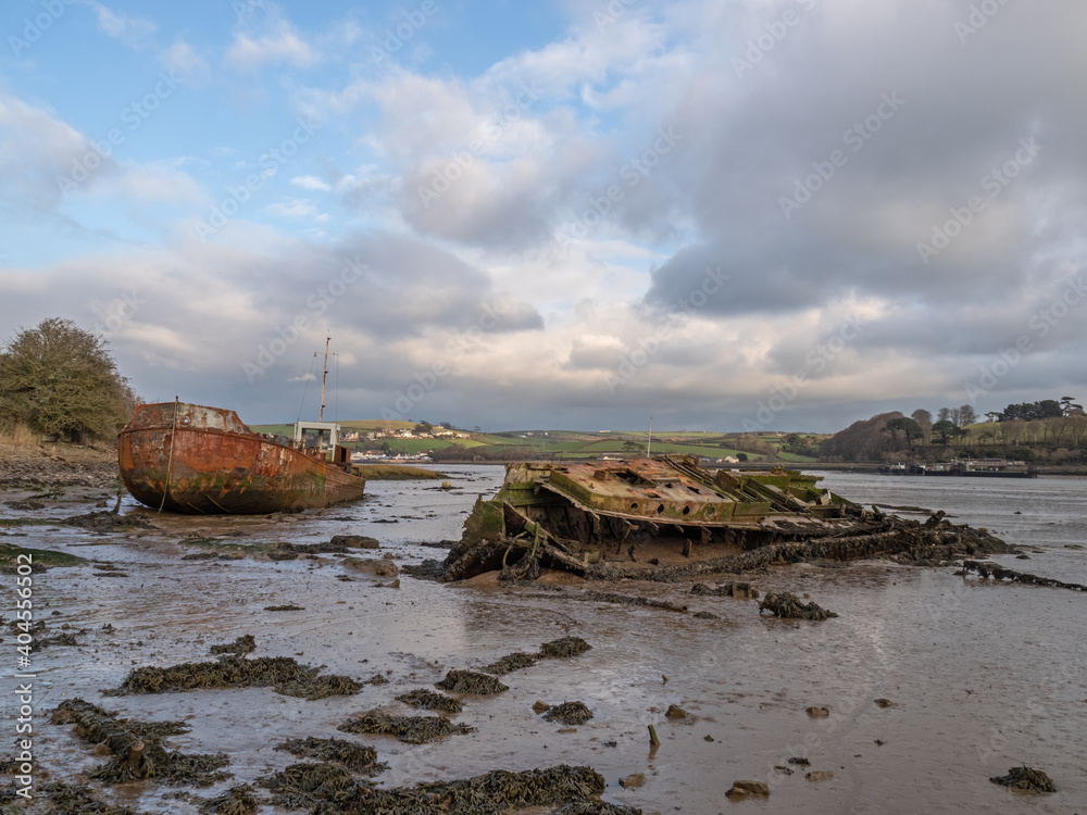 Old, rotting boats, wrecks on the mud flats. River Torridge Estuary near Appledore in north Devon, England, UK.