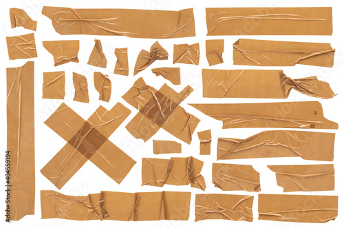 Beige scotch, large set of adhesive packaging tape, different shapes and sizes, crumpled torn strips and pieces on a white background