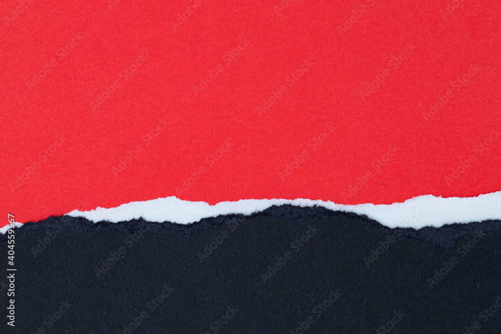Sheets of red and white paper with ragged edges on black background with space for text Sheets of red and white paper with ragged edges on black background with space for text