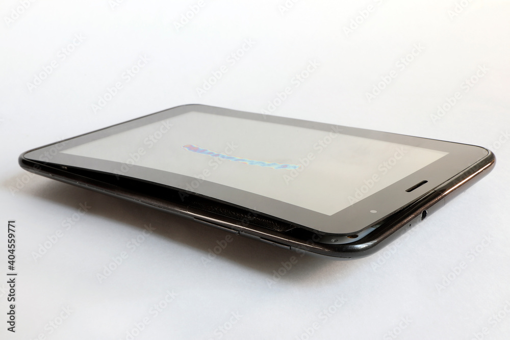 The swollen battery in the tablet tore the screen away from the base of