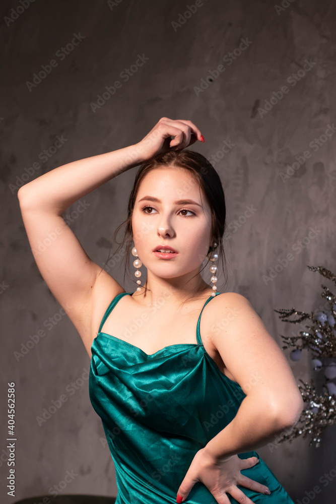 sexy attractive brunette woman in elegant green aquamarine dress in a loft cafe. beautiful sensual girl sexy attractive brunette woman in elegant green aquamarine dress in a loft cafe. beautiful sensual girl