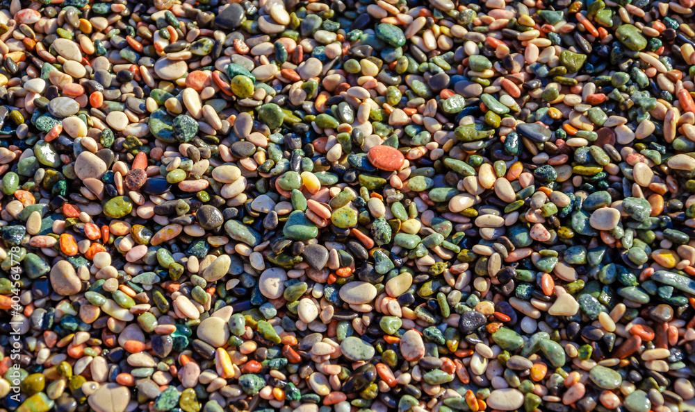 Sea pebbles of different colors in large quantities on the beach. Sea pebbles of different colors in large quantities on the beach.