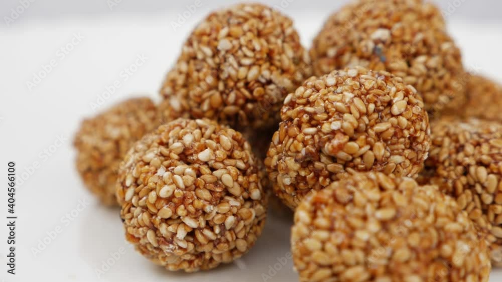 Micro shot of ladoo made from sesame seeds isolated on white background Micro shot of ladoo made from sesame seeds isolated on white background