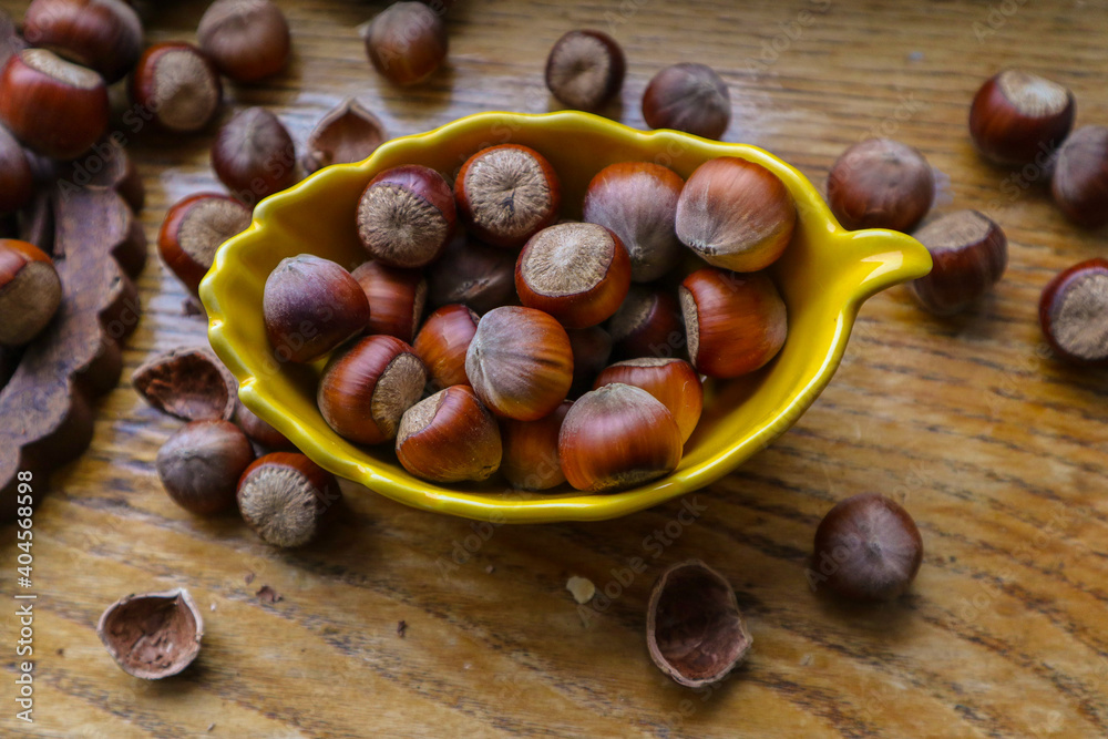 Heap hazelnuts on wooden board wooden background, selective focus with shallow depth of field
Heap hazelnuts on wooden board wooden background, selective focus with shallow depth of field