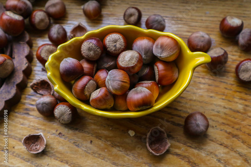 Heap hazelnuts on wooden board wooden background, selective focus with shallow depth of field 