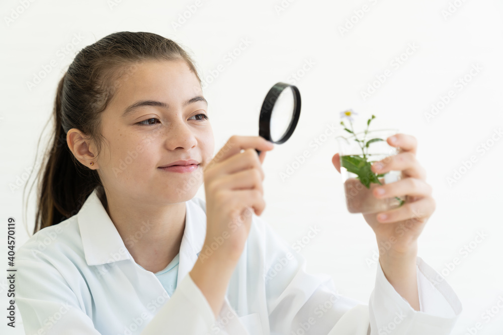 Child girl scientists learning science and looking germs and bacteria through magnifying glass in the laboratory. Education and science. Researcher and discovery concept. Early development of children Child girl scientists learning science and looking germs and bacteria through magnifying glass in the laboratory. Education and science. Researcher and discovery concept. Early development of children