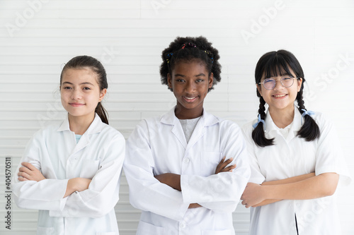 Group of diversity children scientists standing with arms crossed in the laboratory. Asian girl, African American girl scientist, caucasian girl scientist. Educational, Early development of children